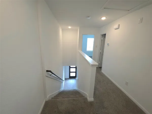 a view of a hallway with staircase