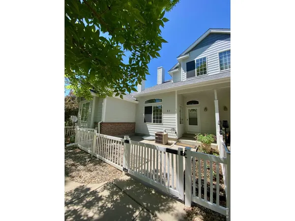 a view of a house with backyard and porch