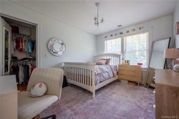 a bedroom with a bed and a chair in it