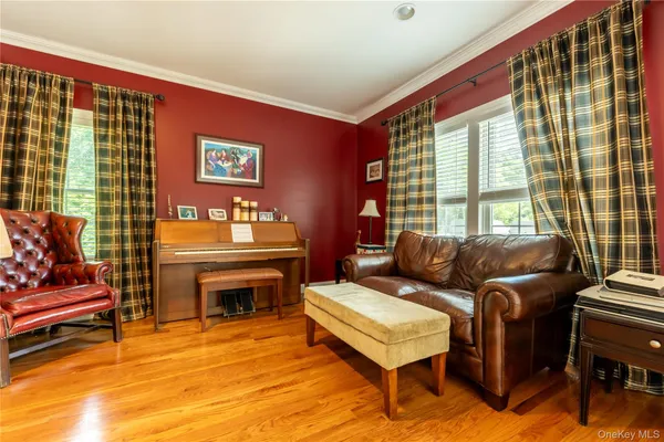 a living room with furniture a rug and a floor to ceiling window