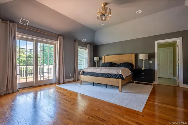 a bedroom with a large bed and a large window