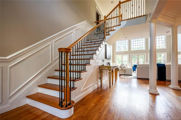 a view of staircase with wooden floor and a floor to ceiling window
