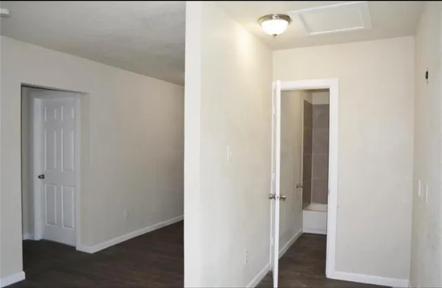 a view of a hallway with wooden floor
