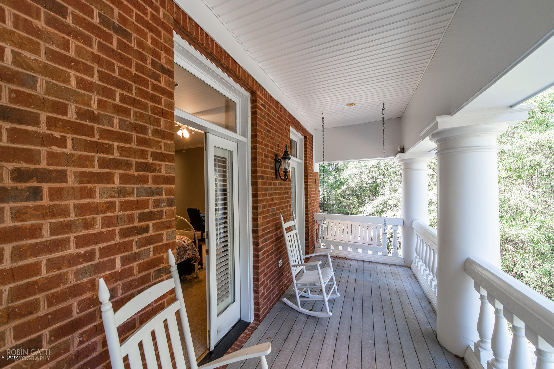 6356 New Forsyth Road Macon, GA 31210 - Photo 44 of 52 a view of a balcony with wooden floor and iron stairs