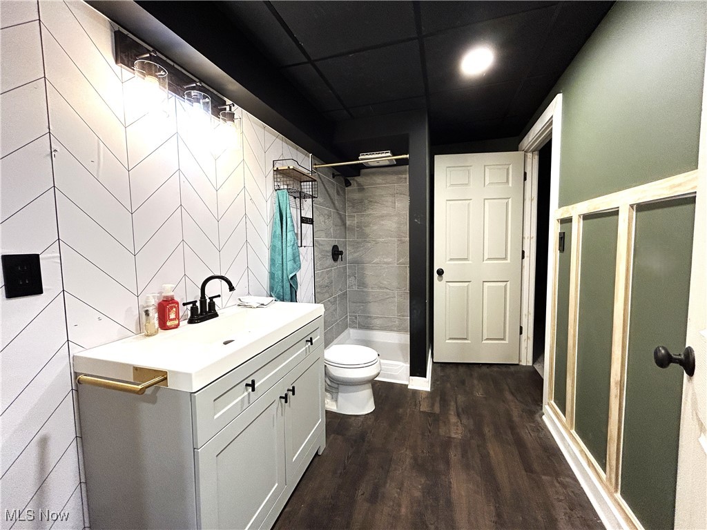 5320 Boston Road Brunswick, OH 44212 - Photo 14 of 18 Basement bathroom with a shower stall, vanity, and dark wood-type flooring