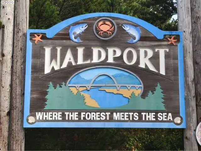 a street sign on a wall next to a road