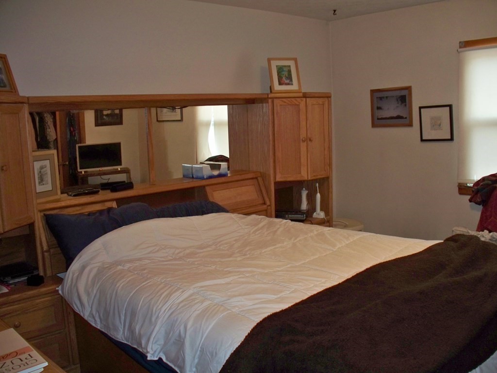 142 Killdeer Road Webster, MA 01570 - Photo 12 of 24 a bedroom with a bed flat screen tv and windows