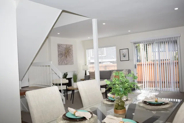 a living room with furniture and flowers