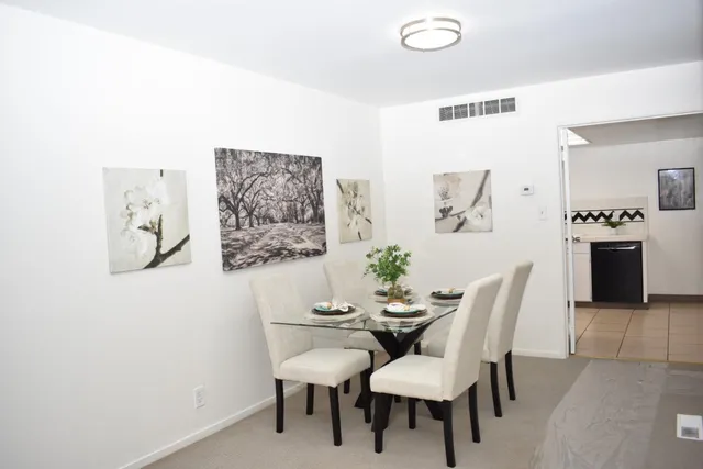 a dining room with furniture and window