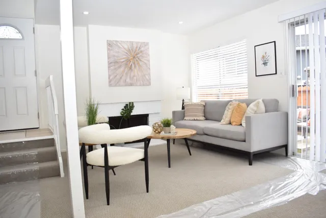 a living room with furniture and a potted plant