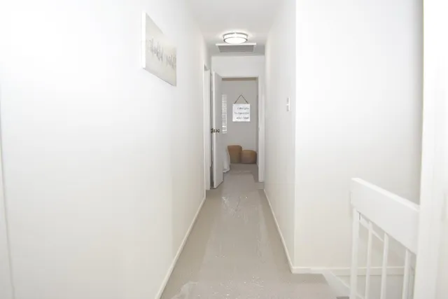 a view of a hallway with a white walls