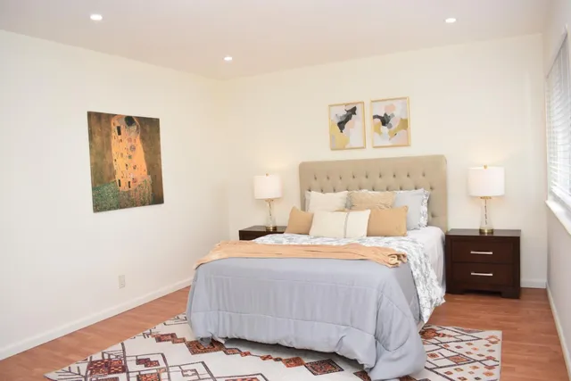 a bedroom with a bed and a lamp