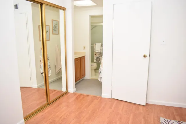 a view of a hallway with wooden floor