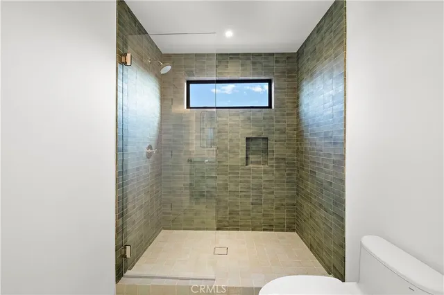 a bathroom with a toilet and a shower