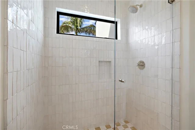 a bathroom with a painting on the wall and shower