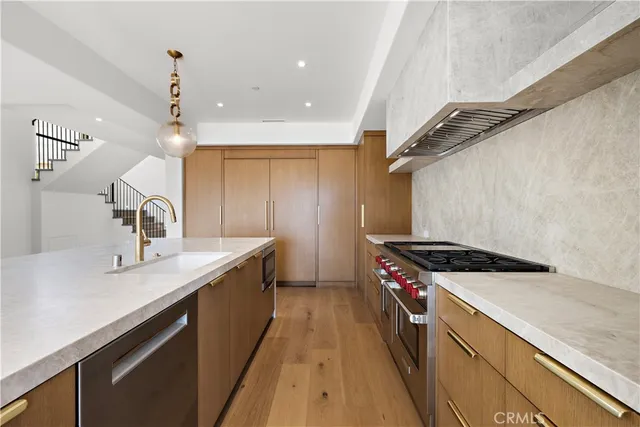 a kitchen with a sink a stove and cabinets