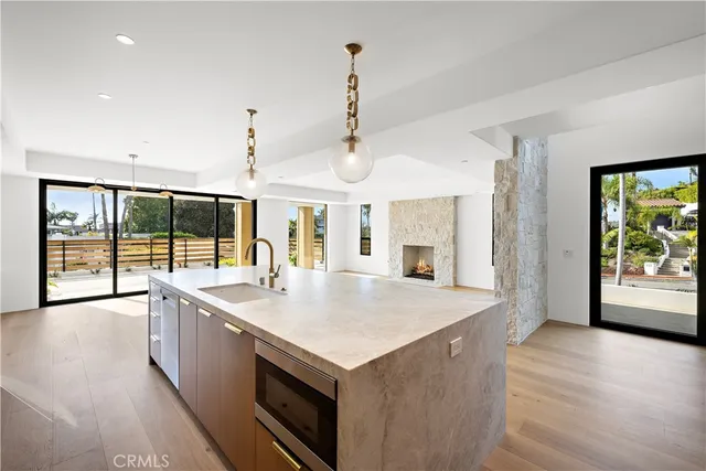 a large kitchen with stainless steel appliances granite countertop a sink and dishwasher with a large window