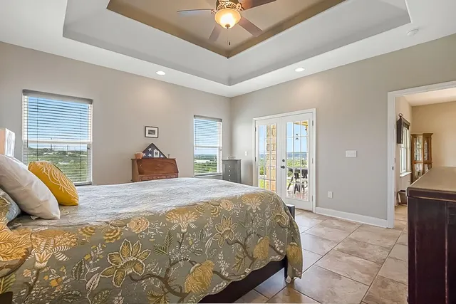 a bedroom with a large bed and a chandelier