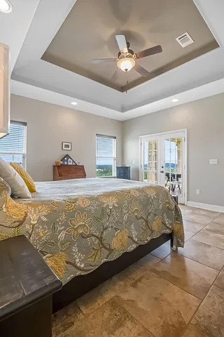 a bedroom with a large bed and a chandelier