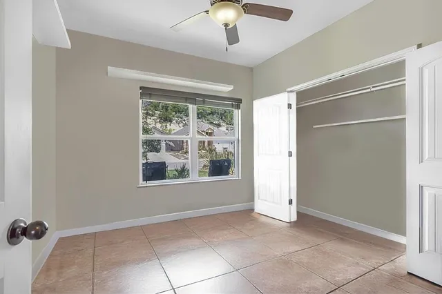 a bathroom with a granite countertop sink a toilet and a mirror