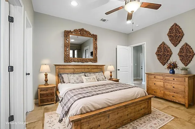a view of an empty room and chandelier fan