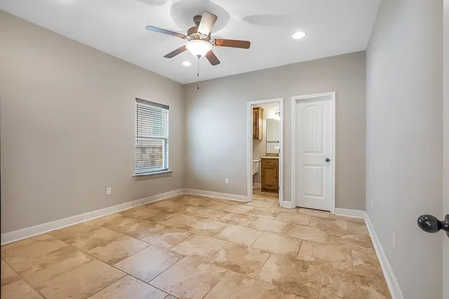 a bathroom with a granite countertop toilet sink and mirror