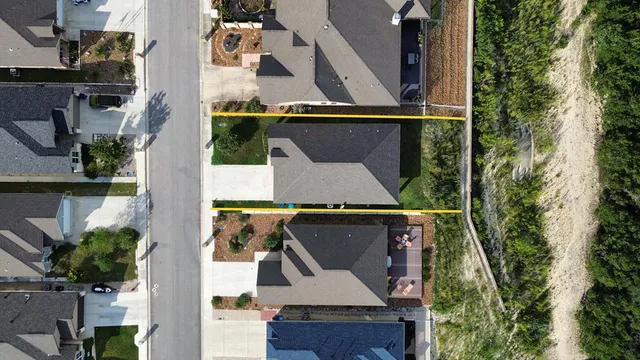 an aerial view of residential houses with outdoor space