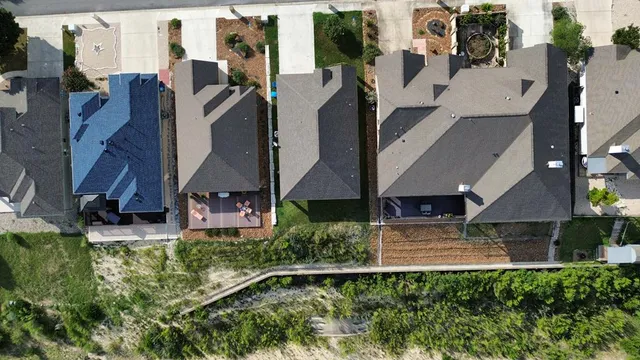 an aerial view of multiple houses with yard