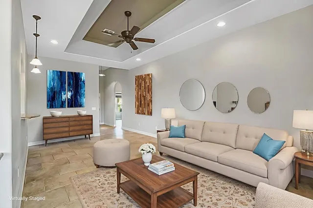 a living room with furniture a rug and a chandelier
