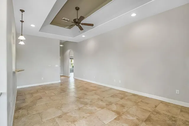 a view of an empty room and a ceiling fan