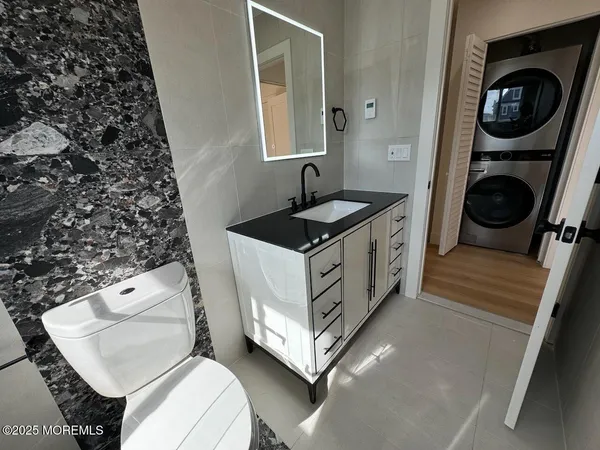 a bathroom with a sink a toilet and a mirror