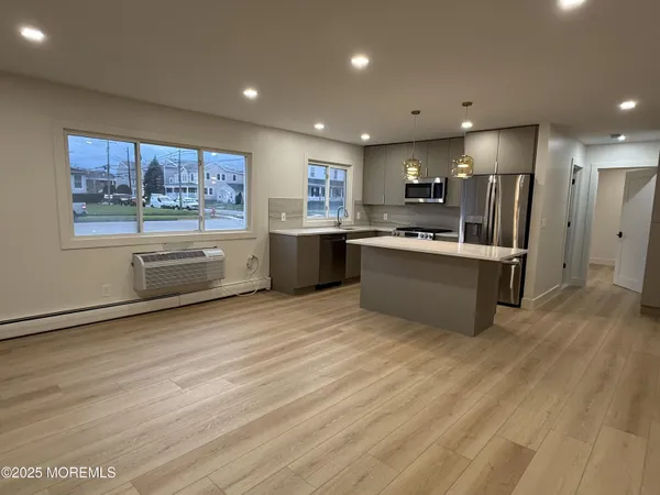 a kitchen with stainless steel appliances granite countertop a refrigerator and a stove top oven