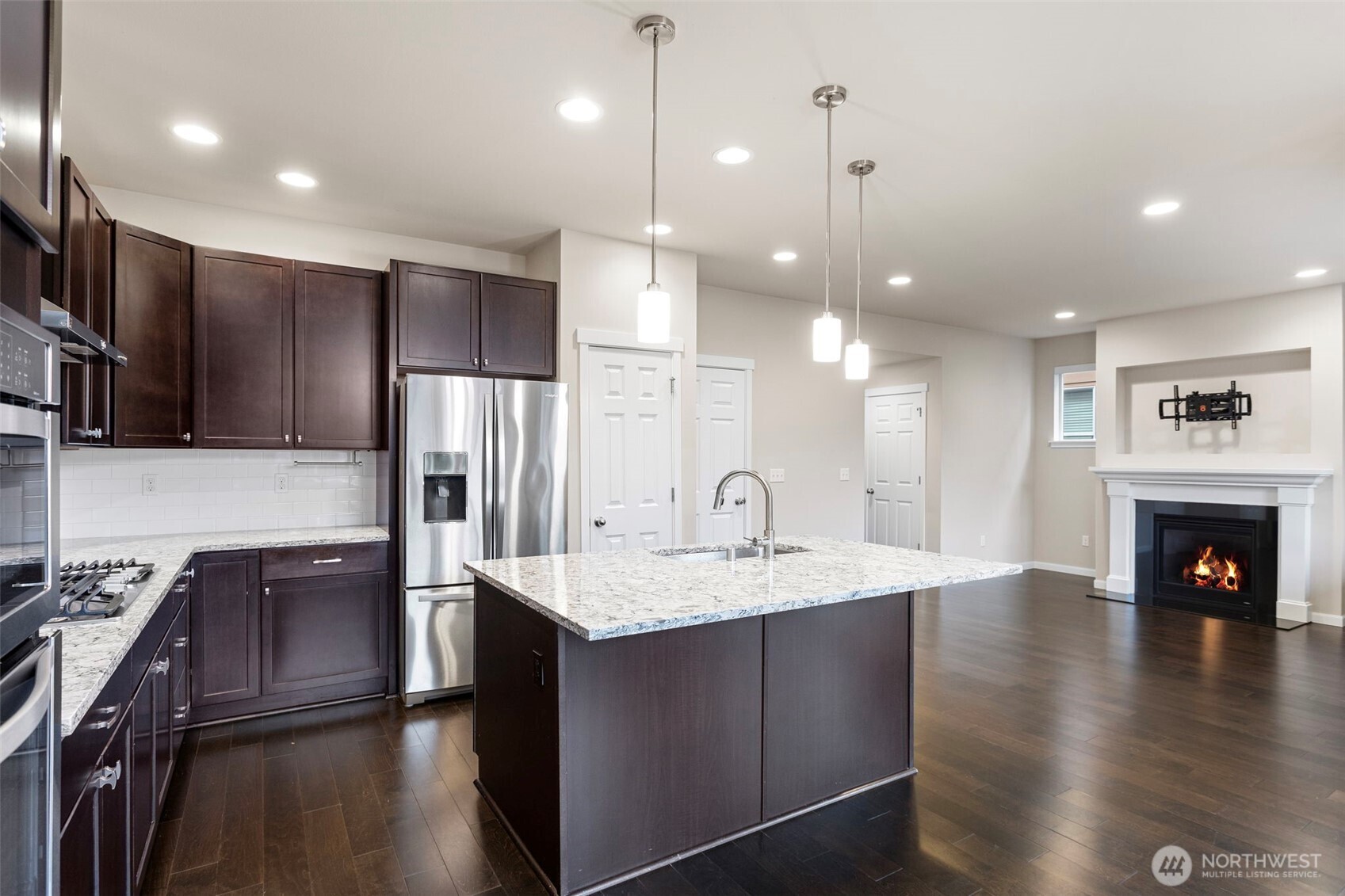 17913 38th Drive Southeast, Unit 20 Bothell, WA 98012 - Photo 11 of 32 a kitchen with stainless steel appliances granite countertop a refrigerator a sink dishwasher a stove and a refrigerator with wooden floor