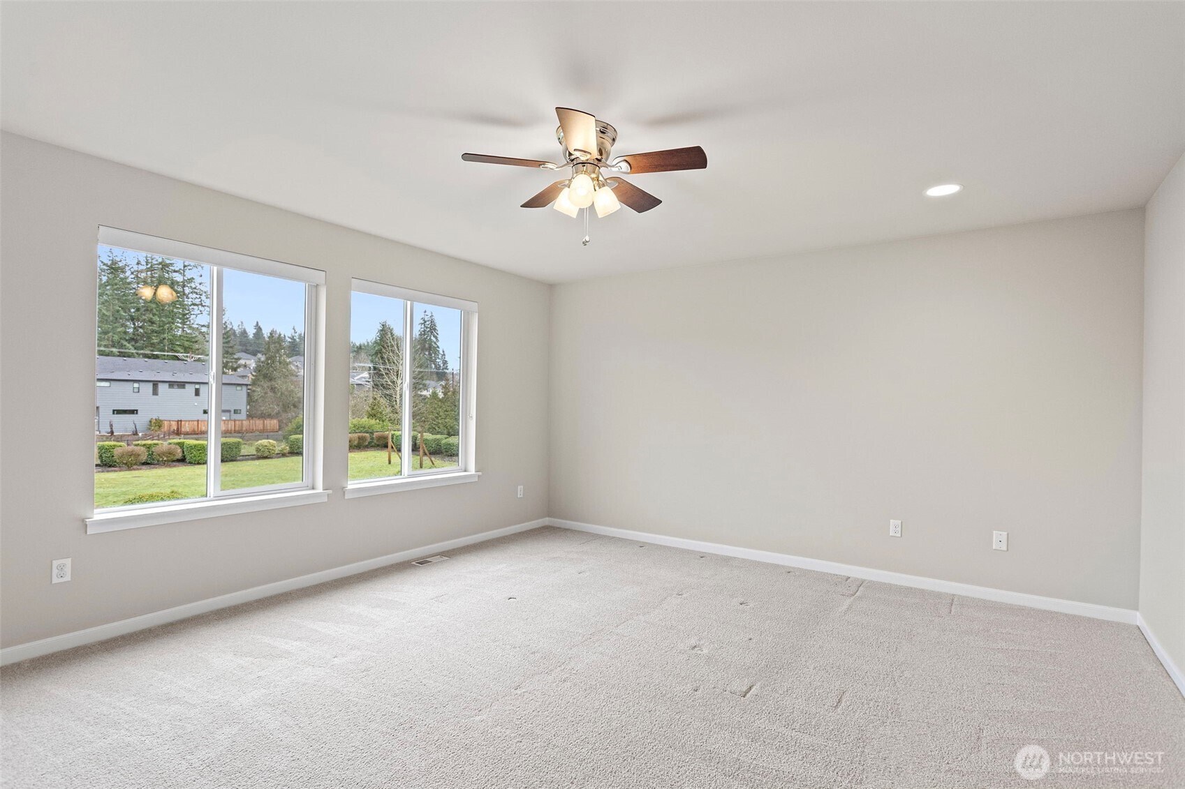 17913 38th Drive Southeast, Unit 20 Bothell, WA 98012 - Photo 21 of 32 an empty room with windows and fan
