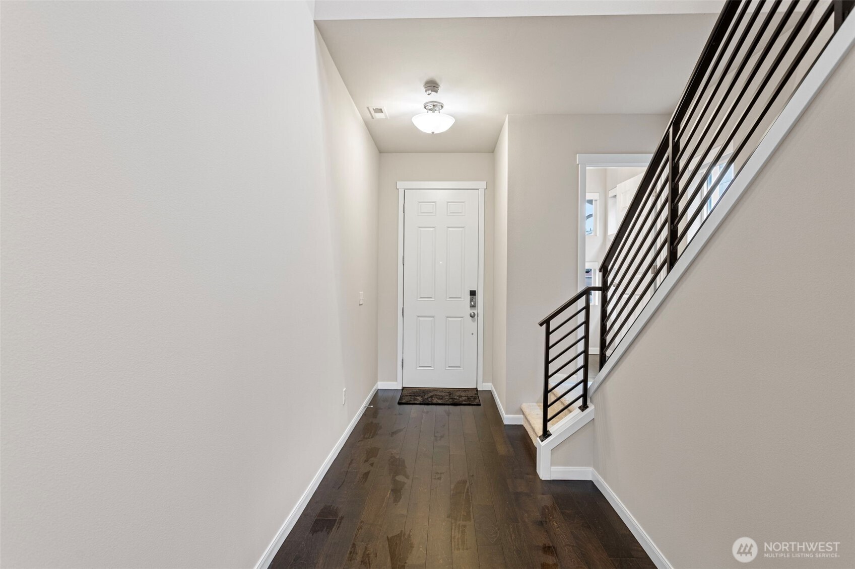 17913 38th Drive Southeast, Unit 20 Bothell, WA 98012 - Photo 3 of 32 a view of a hallway with wooden floor and staircase