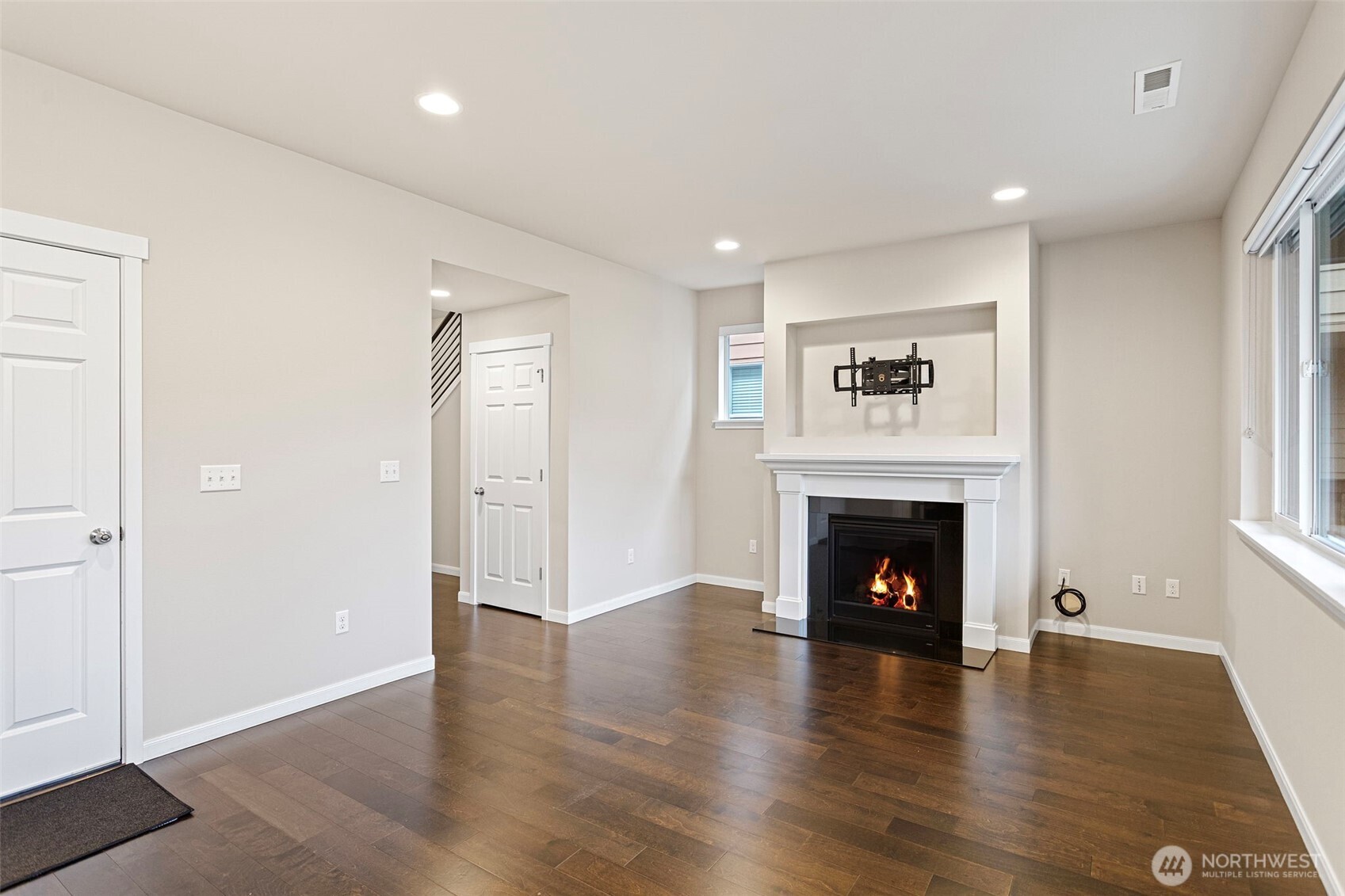 17913 38th Drive Southeast, Unit 20 Bothell, WA 98012 - Photo 5 of 32 a view of an empty room with wooden floor and a window