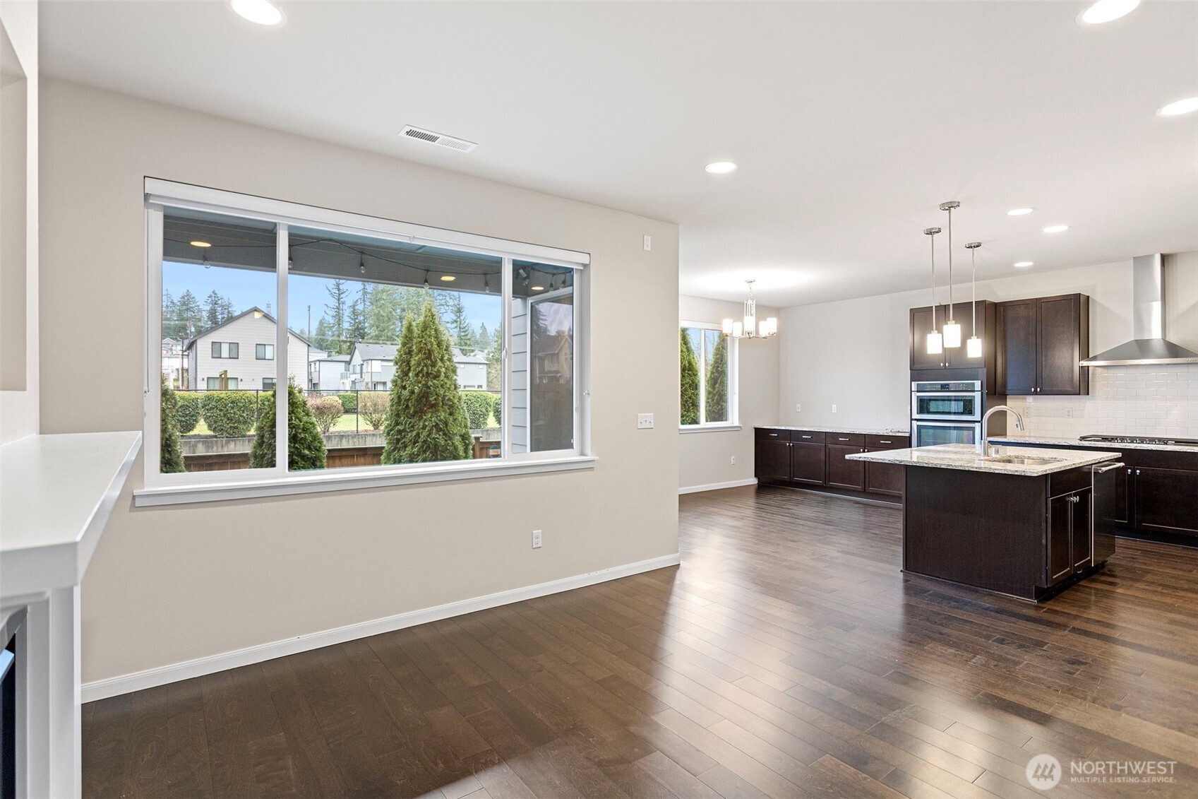 17913 38th Drive Southeast, Unit 20 Bothell, WA 98012 - Photo 6 of 32 a view of kitchen with wooden floor and large window