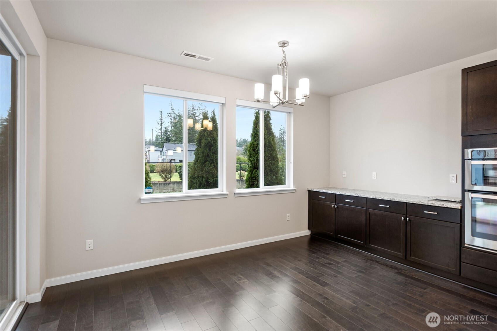 17913 38th Drive Southeast, Unit 20 Bothell, WA 98012 - Photo 8 of 32 wooden floor in an empty room with a window