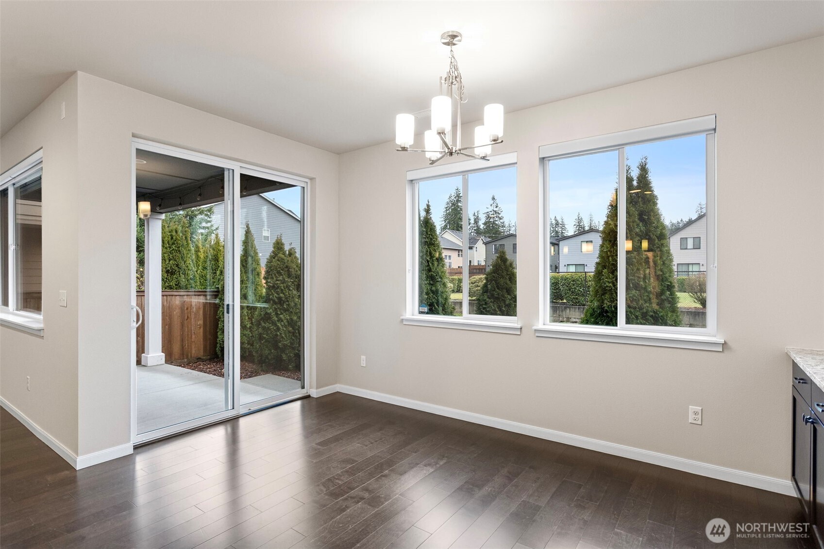 17913 38th Drive Southeast, Unit 20 Bothell, WA 98012 - Photo 9 of 32 a view of a livingroom with wooden floor and a chandelier