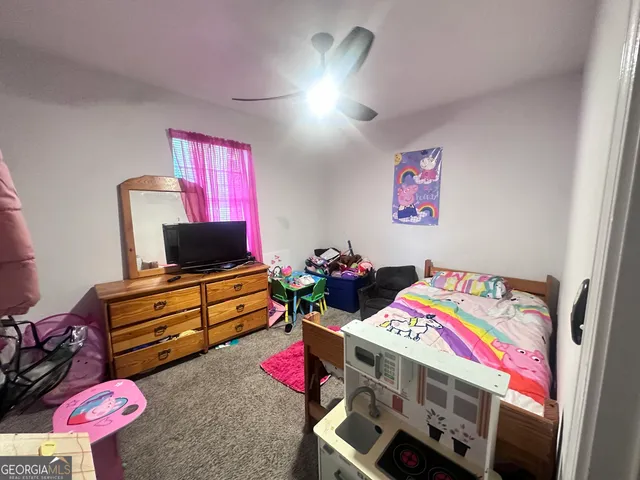 a bedroom with furniture and a flat screen tv