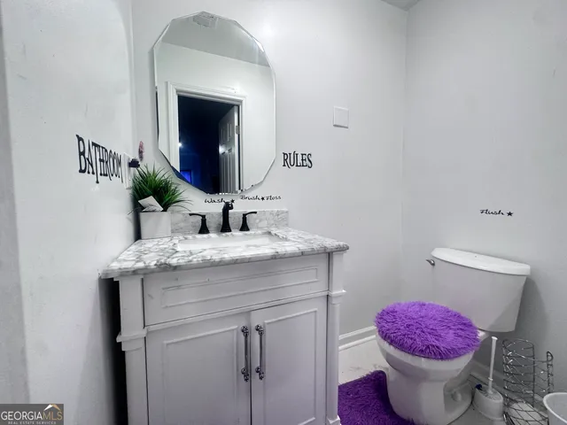 a bathroom with a sink toilet and mirror