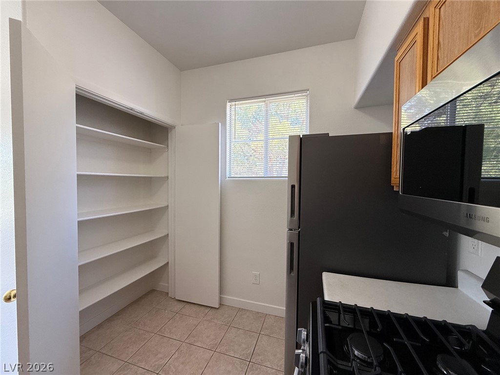 9050 West Warm Springs Road, Unit 2002 Las Vegas, NV 89148 - Photo 15 of 46 This functional kitchen provides ample storage and essential appliances for daily living.