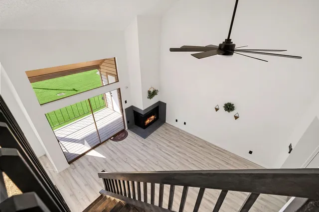 a view of staircase with lots of frames on wall and wooden floor
