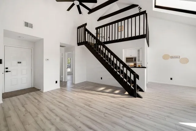 a view of entryway with wooden floor and stairs