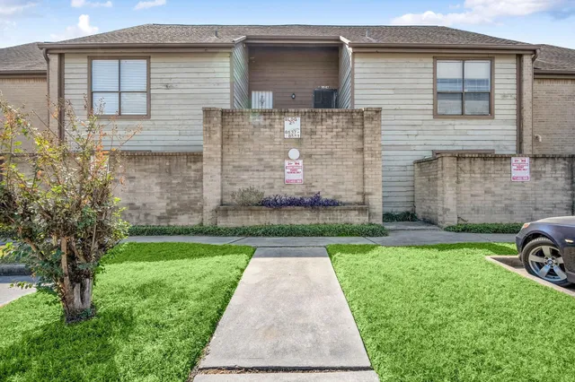 a view of wooden house with a large door