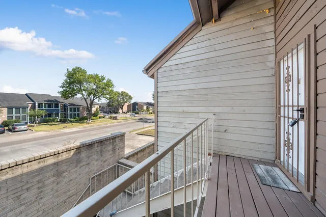 a porch with wooden floor and glass door