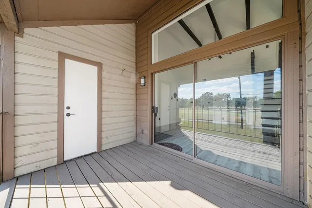 a view of a balcony with wooden floor