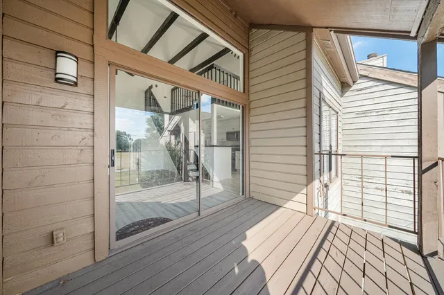 a view of a balcony with wooden floor