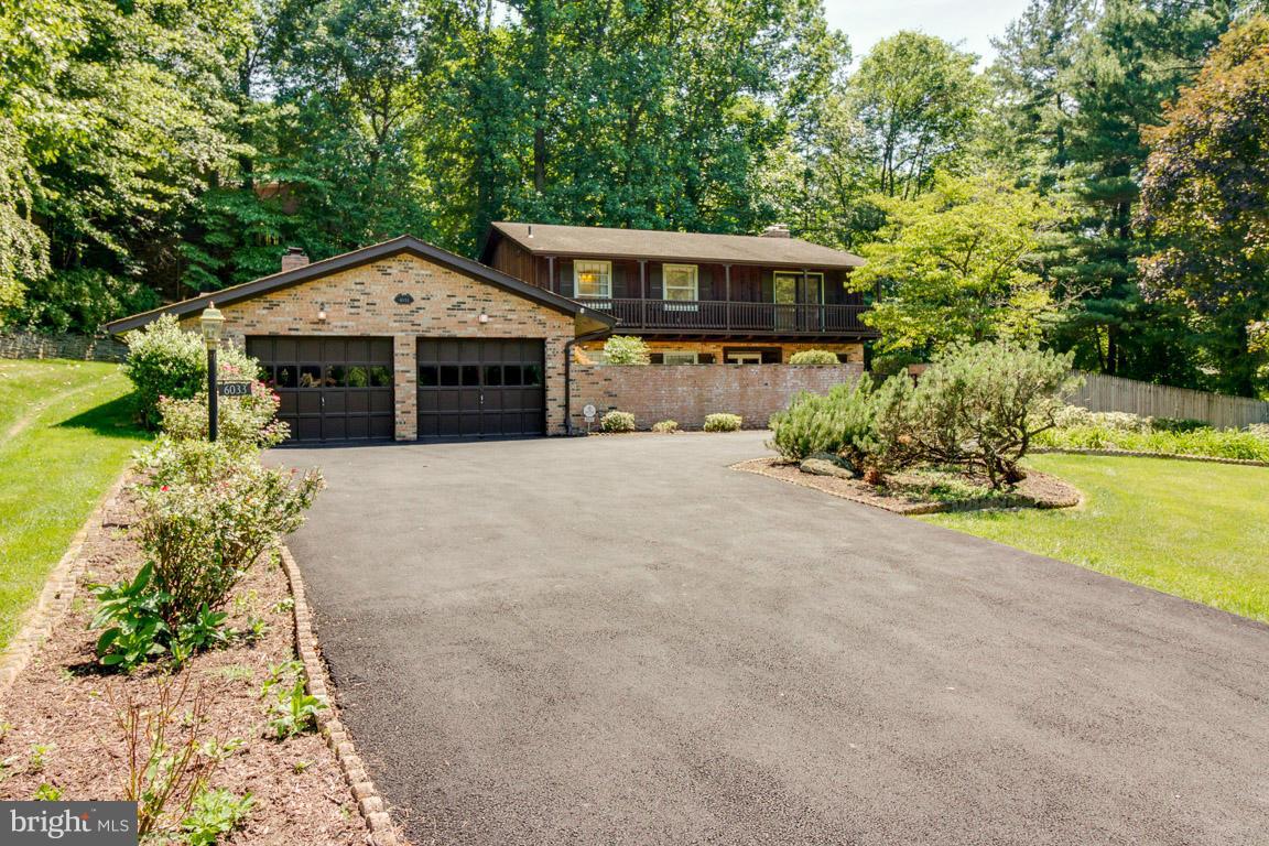 6033 Chesterbrook Road McLean, VA 22101 - Photo 1 of 24 front view of a house with a yard