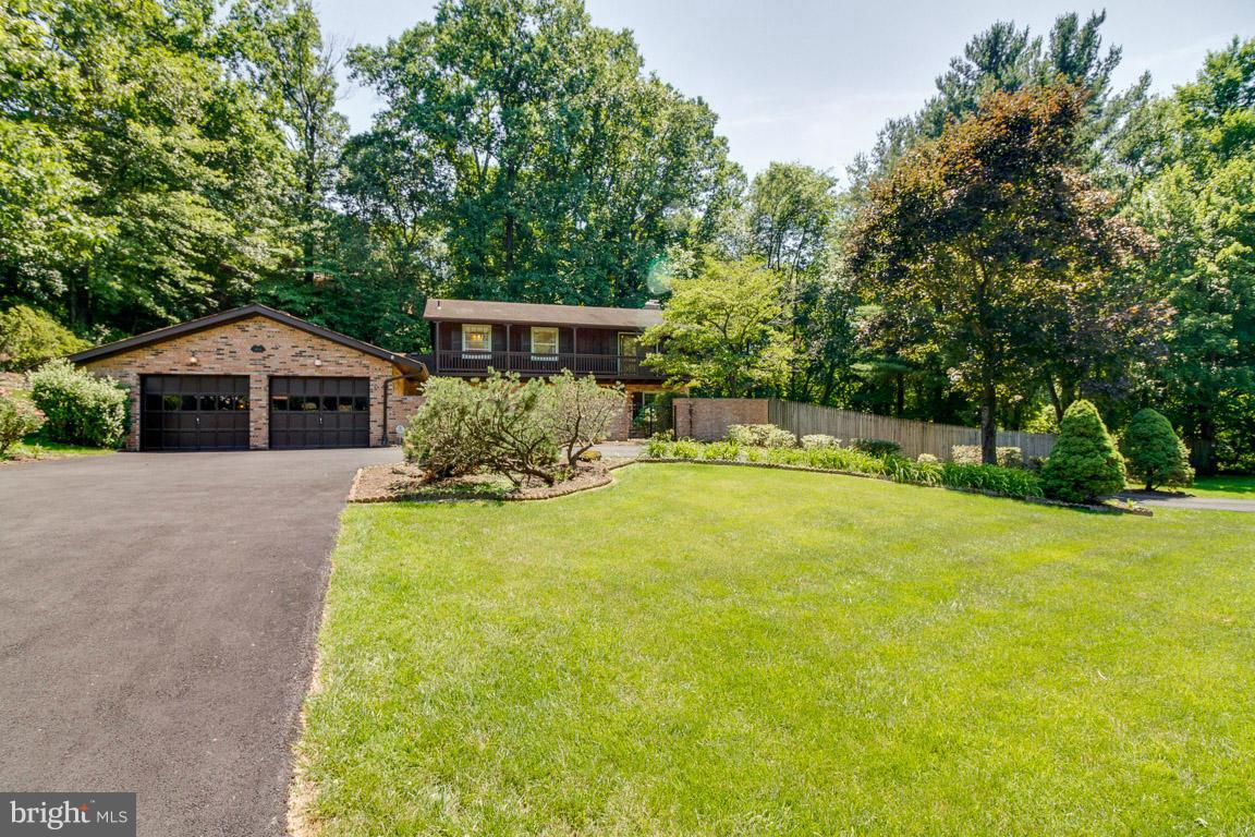 6033 Chesterbrook Road McLean, VA 22101 - Photo 2 of 24 a front view of a house with yard and green space